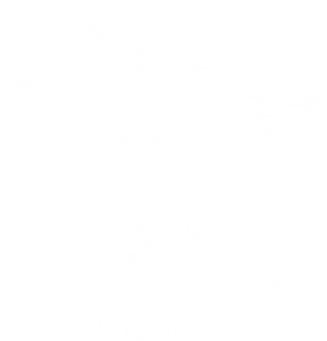 Logo with “1872” above “INN,” a buffalo icon below, and the words “West Yellowstone • Montana” in a semicircle at the bottom.